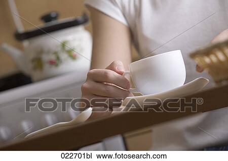 detail of young woman sitting at table with cup View Large Photo Image Stock Image - detail of young woman sitting at table with cup. Fotosearch
