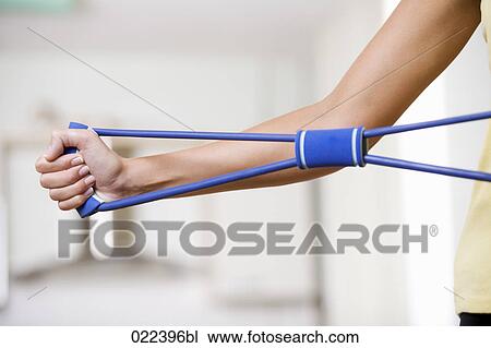 detail of young woman using tool to strengthen muscles View Large Photo Image Stock Image - detail of young woman using tool to strengthen muscles. Fotosearch