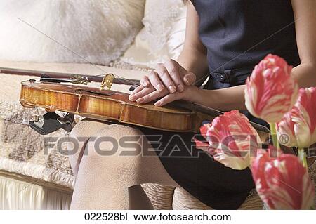 detail of young woman with violin sitting on sofa View Large Photo Image Stock Image - detail of young woman with violin sitting on sofa. Fotosearch