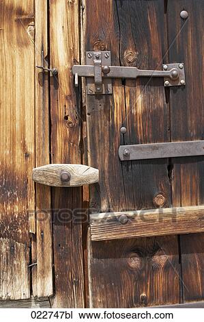 Stock Image - door of alpine hut. Fotosearch