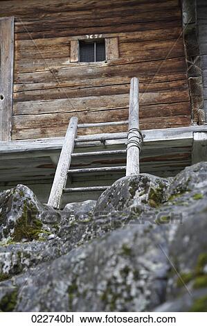 Stock Image - ladder leading to alpine hut. Fotosearch