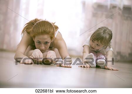 little girl watching her mother doing stretching exercises View Large Photo Image Stock Image - little girl watching her mother doing stretching exercises. Fotosearch