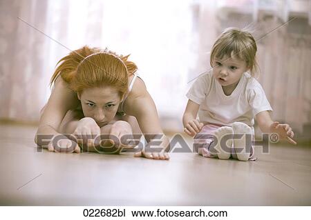 little girl watching her mother doing stretching exercises View Large Photo Image Stock Image - little girl watching her mother doing stretching exercises. Fotosearch