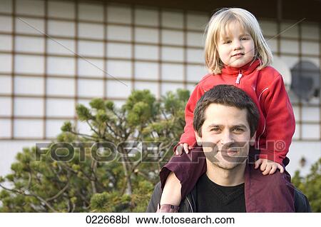 portrait of father carrying young daughter on his shoulders View Large Photo Image Stock Image - portrait of father carrying young daughter on his shoulders. Fotosearch