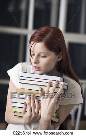 portrait of female student carrying pile of books View Large Photo Image Stock Image - portrait of female student carrying pile of books. Fotosearch