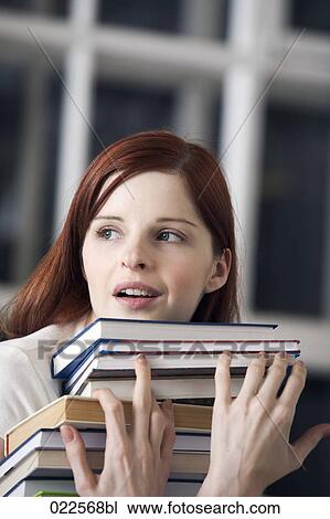 portrait of female student carrying pile of books View Large Photo Image Stock Image - portrait of female student carrying pile of books. Fotosearch