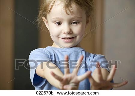 portrait of little girl looking at her hands View Large Photo Image Stock Image - portrait of little girl looking at her hands. Fotosearch
