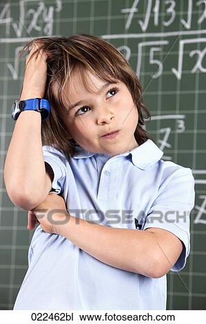 portrait of young boy in classroom in front pof blackboard View Large Photo Image Stock Image - portrait of young boy in classroom in front pof blackboard. Fotosearch