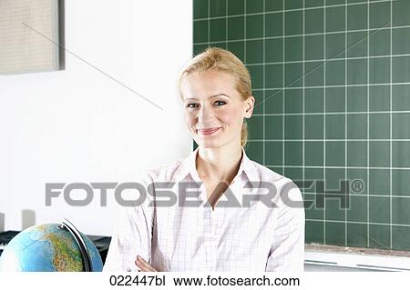 portrait of young female teacher in classroom View Large Photo Image Stock Image - portrait of young female teacher in classroom. Fotosearch