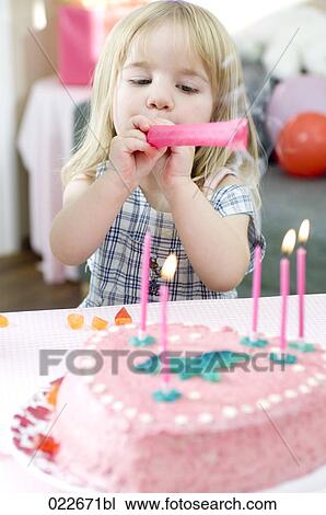portrait of young girl blowing out candles on birthday cake View Large Photo Image Stock Image - portrait of young girl blowing out candles on birthday cake. Fotosearch