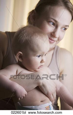 portrait of young mother holding baby View Large Photo Image Stock Image - portrait of young mother holding baby. Fotosearch
