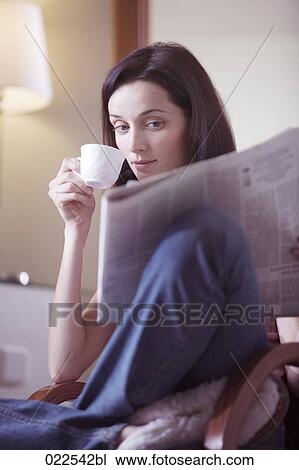 portrait of young woman at home reading newspaper and drinking coffee View Large Photo Image Stock Image - portrait of young woman at home reading newspaper and drinking coffee. Fotosearch