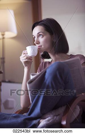 portrait of young woman at home reading newspaper and drinking coffee View Large Photo Image Stock Image - portrait of young woman at home reading newspaper and drinking coffee. Fotosearch