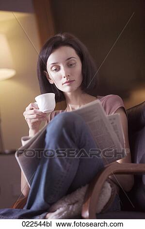 portrait of young woman at home reading newspaper and drinking coffee View Large Photo Image Stock Image - portrait of young woman at home reading newspaper and drinking coffee. Fotosearch