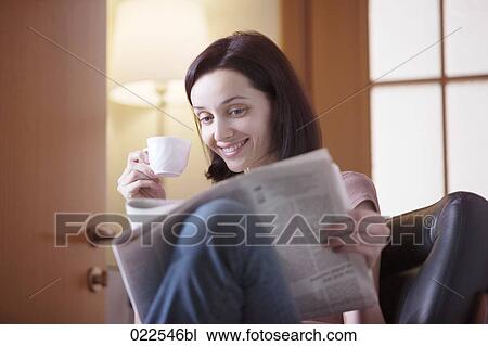 portrait of young woman at home reading newspaper and drinking coffee View Large Photo Image Stock Image - portrait of young woman at home reading newspaper and drinking coffee. Fotosearch