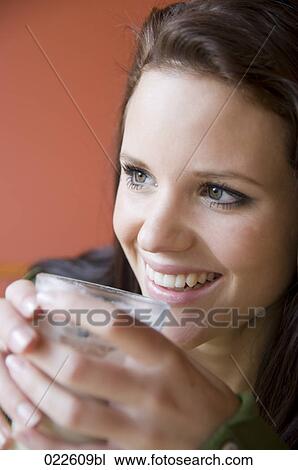 portrait of young woman drinking coffee View Large Photo Image Stock Image - portrait of young woman drinking coffee. Fotosearch
