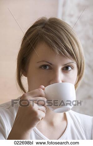 portrait of young woman drinking from cup View Large Photo Image Stock Image - portrait of young woman drinking from cup. Fotosearch