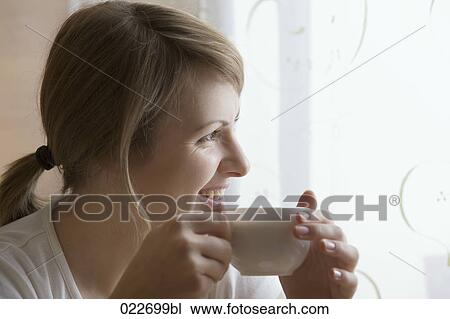 portrait of young woman holding cup View Large Photo Image Stock Image - portrait of young woman holding cup. Fotosearch