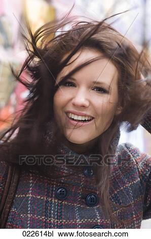 portrait of young woman with windswept hair View Large Photo Image Stock Image - portrait of young woman with windswept hair. Fotosearch
