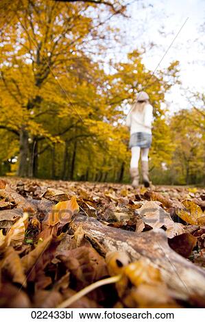 rear view of teenage girl running through park in autumn View Large Photo Image Stock Image - rear view of teenage girl running through park in autumn. Fotosearch