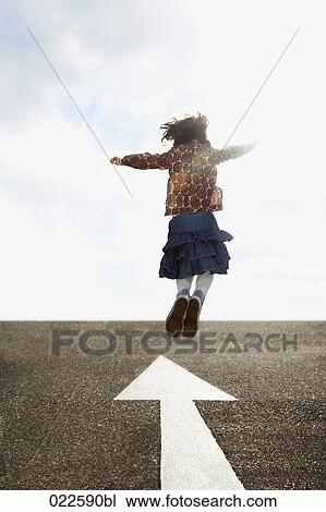 rear view of young girl jumping on road View Large Photo Image Stock Image - rear view of young girl jumping on road. Fotosearch