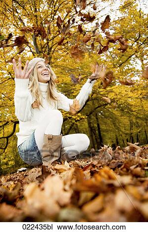 teenage girl in park playing with autumn leaves View Large Photo Image Stock Image - teenage girl in park playing with autumn leaves. Fotosearch