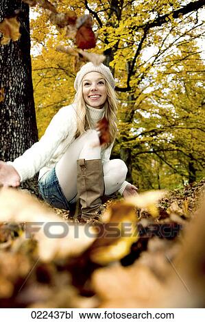 teenage girl in park playing with autumn leaves View Large Photo Image Stock Image - teenage girl in park playing with autumn leaves. Fotosearch
