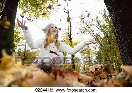 teenage girl in park playing with autumn leaves View Large Photo Image Stock Image - teenage girl in park playing with autumn leaves. Fotosearch