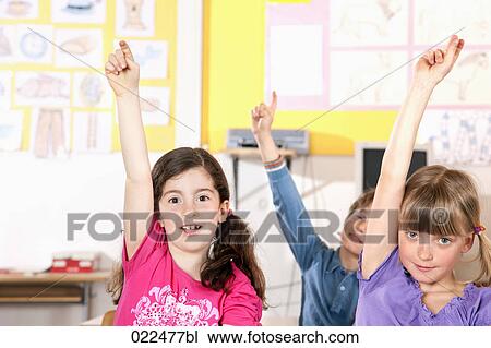 three pupils raising their fingers in classroom View Large Photo Image Stock Image - three pupils raising their fingers in classroom. Fotosearch