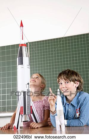 two pupils in classroom with model of rocket View Large Photo Image Stock Image - two pupils in classroom with model of rocket. Fotosearch