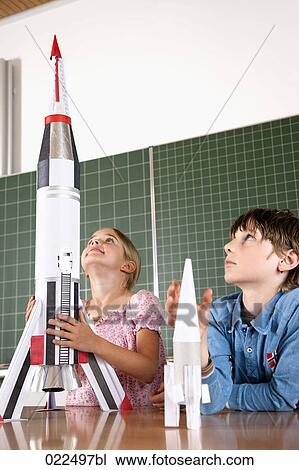 two pupils in classroom with model of rocket View Large Photo Image Stock Image - two pupils in classroom with model of rocket. Fotosearch