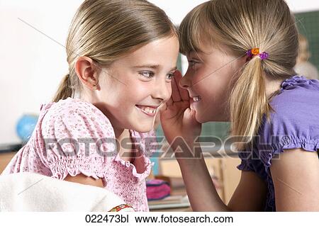 two young girls whispering to each other in classroom View Large Photo Image Stock Image - two young girls whispering to each other in classroom. Fotosearch