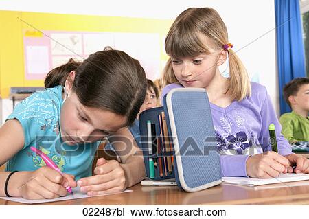two young girls writing test in classroom one trying to cheat View Large Photo Image Stock Image - two young girls writing test in classroom one trying to cheat. Fotosearch