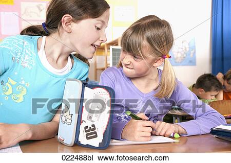 two young girls writing test in classroom one trying to cheat View Large Photo Image Stock Image - two young girls writing test in classroom one trying to cheat. Fotosearch
