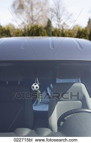 view into car with little toy football and mp3 player hanging on driving mirror View Large Photo Image Stock Image - view into car with little toy football and mp3 player hanging on driving mirror. Fotosearch