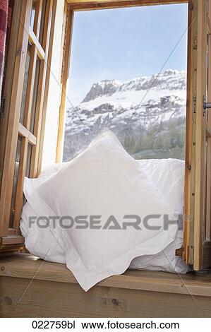 Stock Image - white bedclothes in window at Val d´Isere in France. Fotosearch