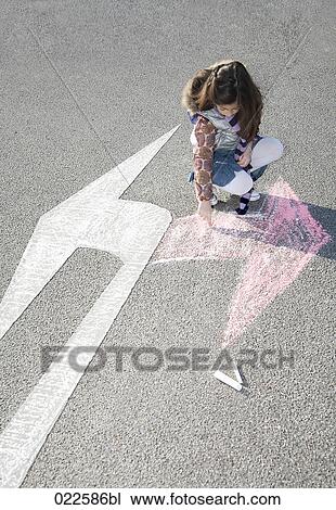 young girl drawing arrow in opposite direction of road sign View Large Photo Image Stock Image - young girl drawing arrow in opposite direction of road sign. Fotosearch