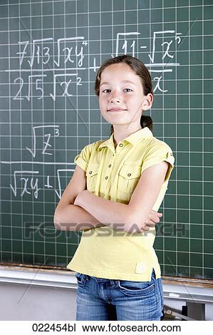 young girl in front of blackboard in classroom View Large Photo Image Stock Image - young girl in front of blackboard in classroom. Fotosearch