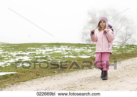 young girl walking on path in winter View Large Photo Image Stock Image - young girl walking on path in winter. Fotosearch