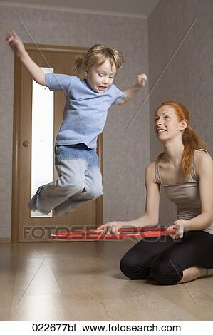 young mother and her daughter doing exercises at home View Large Photo Image Stock Image - young mother and her daughter doing exercises at home. Fotosearch