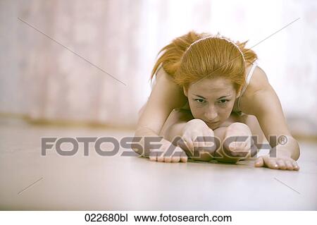young woman doing stretching exercises at home View Large Photo Image Stock Image - young woman doing stretching exercises at home. Fotosearch