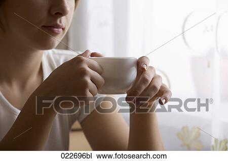 young woman holding cup View Large Photo Image Stock Image - young woman holding cup. Fotosearch
