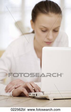 young woman lying on floor working with laptop computer View Large Photo Image Stock Image - young woman lying on floor working with laptop computer. Fotosearch