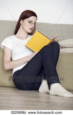 young woman sitting on floor reading book View Large Photo Image Stock Image - young woman sitting on floor reading book. Fotosearch