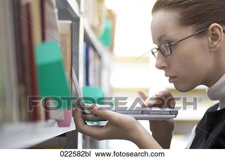 young woman working with laptop computer in library View Large Photo Image Stock Image - young woman working with laptop computer in library. Fotosearch