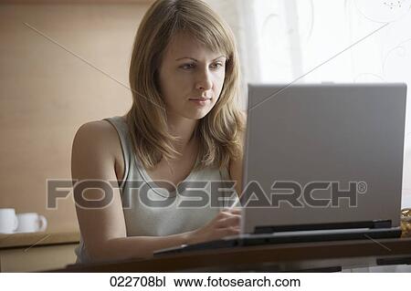 young woman working with laptop computer at home View Large Photo Image Stock Image - young woman working with laptop computer at home. Fotosearch