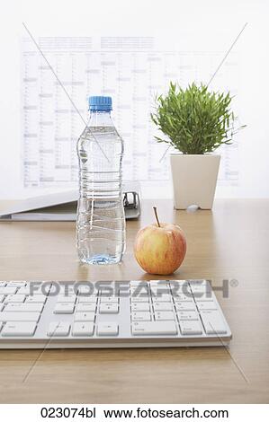 computer keyboard apple water bottle file and plant on table View Large Photo Image Stock Image - computer keyboard apple water bottle file and plant on table. Fotosearch