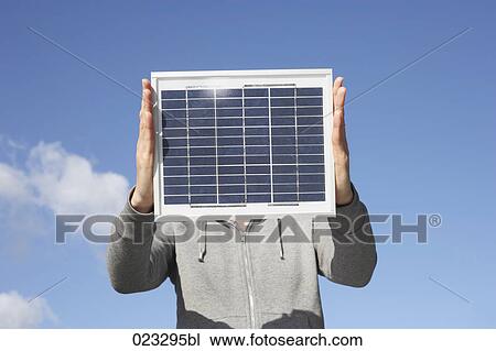 detail of woman holding solar panel up against sky View Large Photo Image Stock Image - detail of woman holding solar panel up against sky. Fotosearch