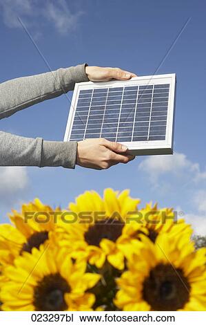 detail of woman holding solar panel up against sky View Large Photo Image Stock Image - detail of woman holding solar panel up against sky. Fotosearch