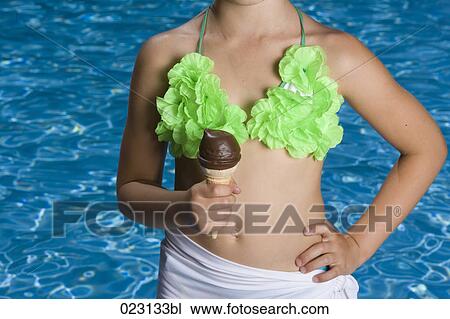 Stock Image - detail of young girl with ice cream in summer. Fotosearch